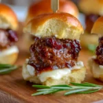 cranberry meatball sliders on a wooden board