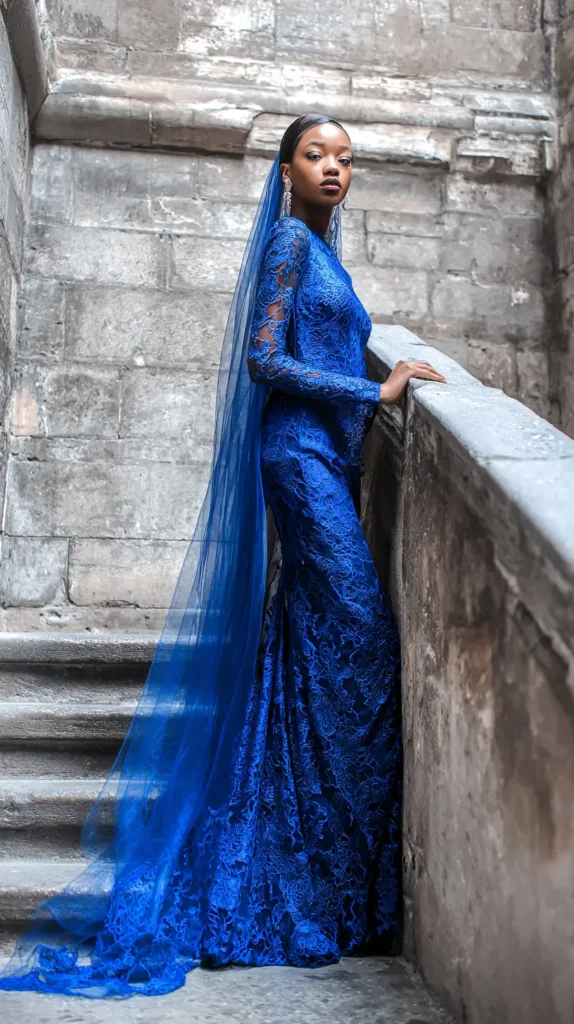 woman in blue gown, on steps outside, veil